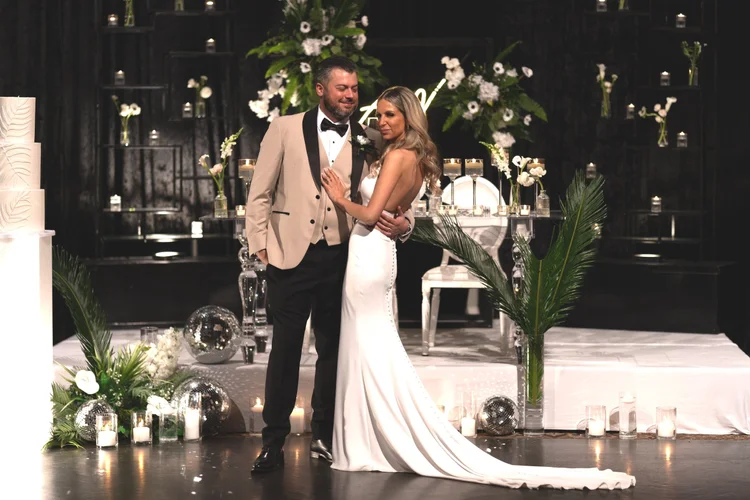 Bride and groom dancing at candlelit wedding reception