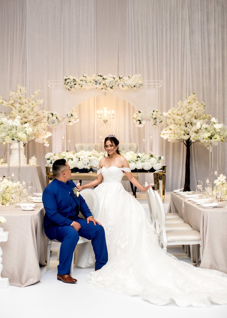 Bride and groom seated together during wedding portraits