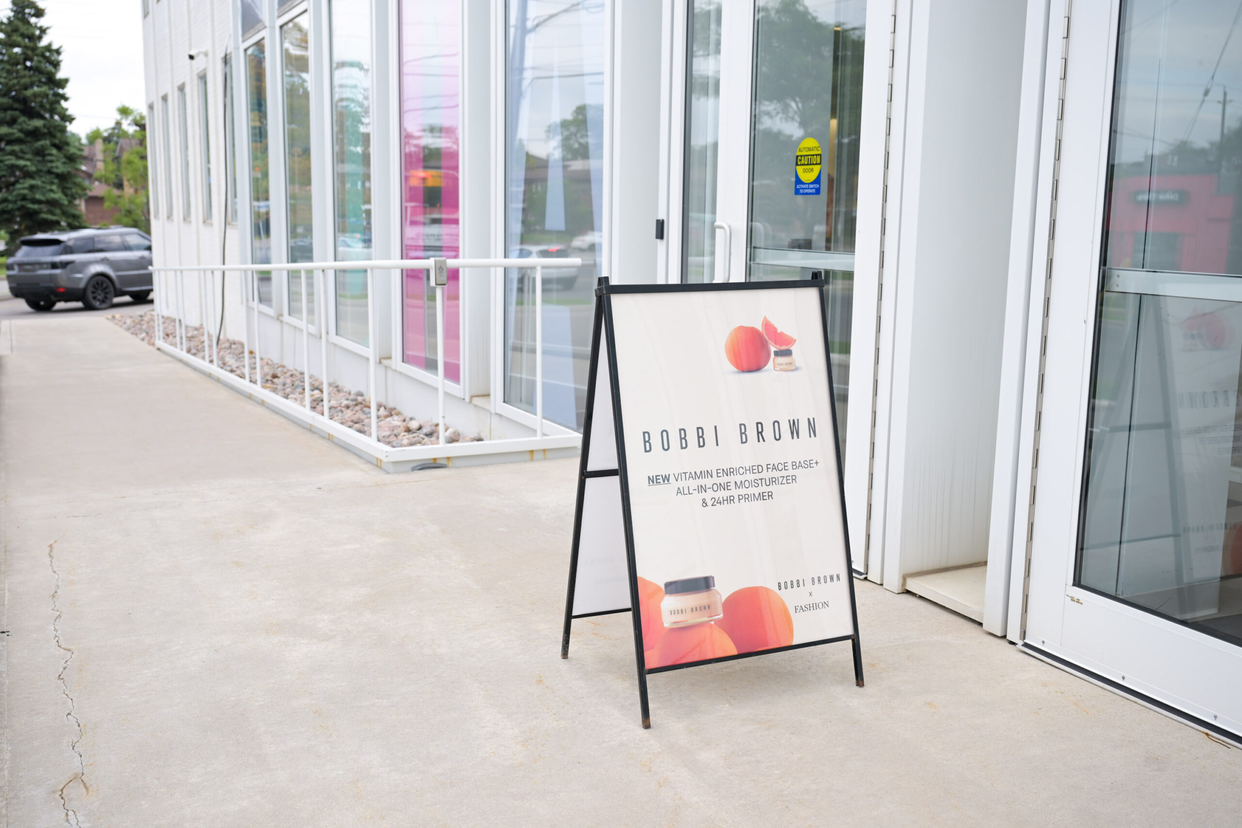 Outdoor Bobbi Brown branded A-frame welcome sign at the FASHION event entrance