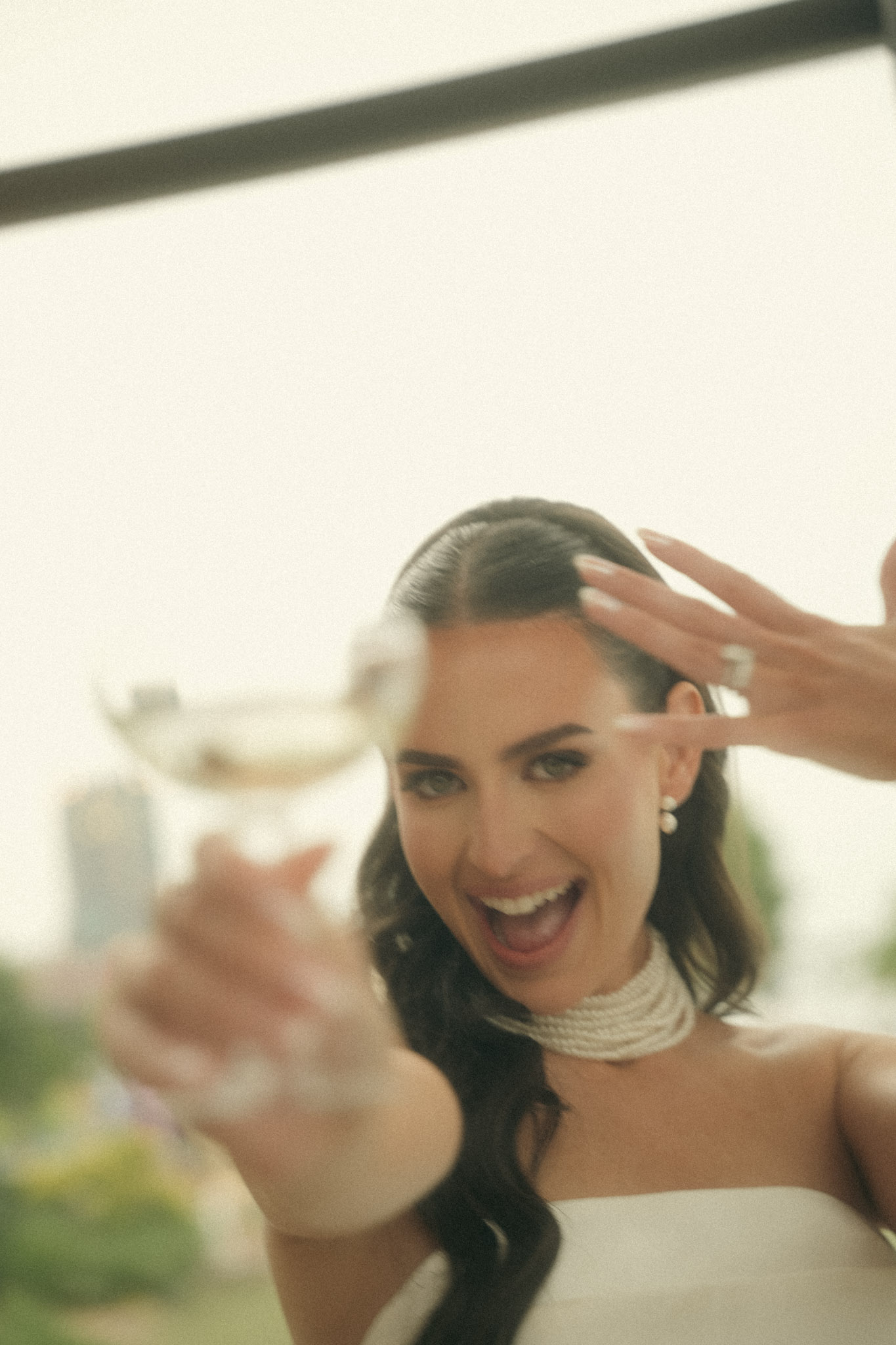 Bride celebrating with a raised glass at a luxury wedding