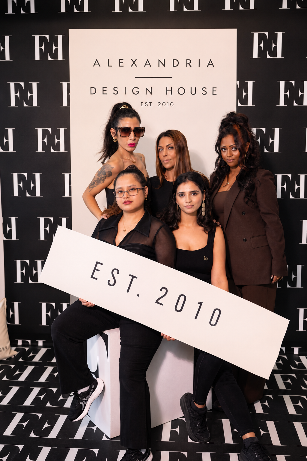 Alexandria Design House team portrait with EST. 2010 backdrop at Bobbi Brown x Fashion Magazine event